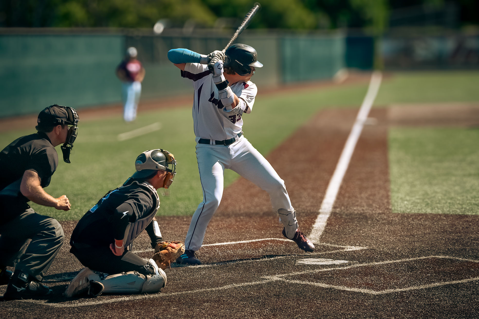 Coach in the dugout with the game in front of him