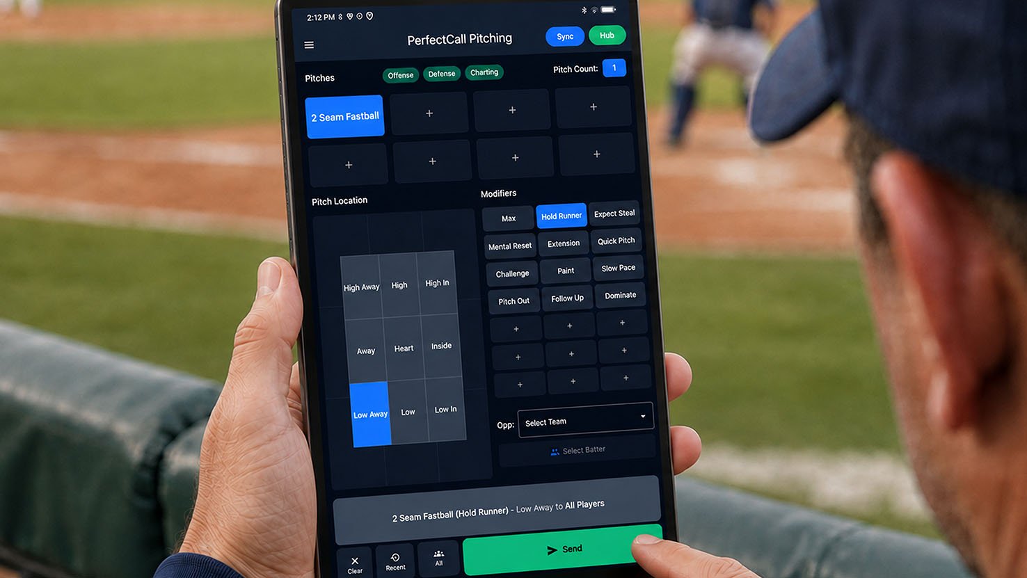 Coach holding the PerfectCall tablet in the dugout